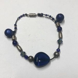 Handmade beaded bracelet in brass and blue with bells. Original design